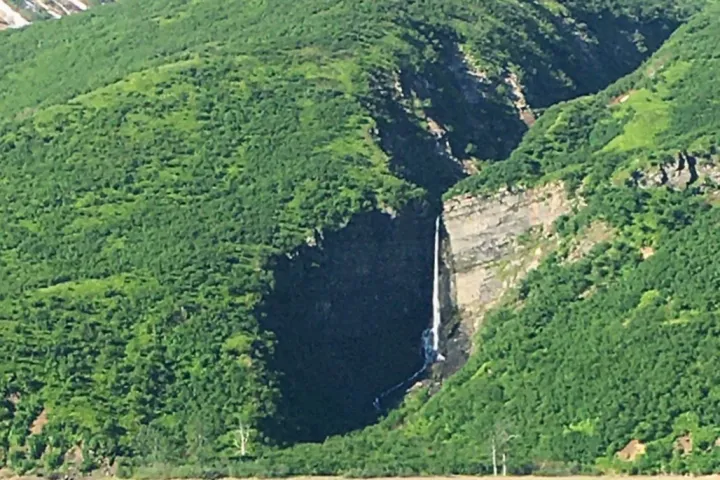 a view of a large body of water with a mountain in the background