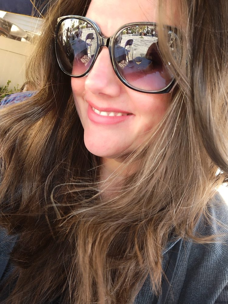 a close up of a woman wearing sunglasses