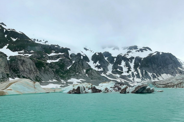 a large body of water with a mountain in the background